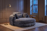 Asolo chaise lounge in Grey chenille in a panelled Toronto living room at dusk beside a brass floor lamp