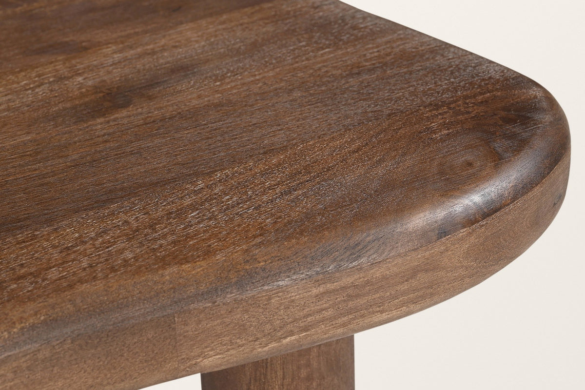 Close-up of the Atri top in dark walnut: the fully rounded edge and the grain of solid mango wood