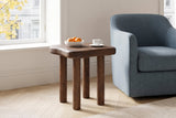 Atri side table in dark walnut beside a dusty-blue wool armchair in a Montreal living room
