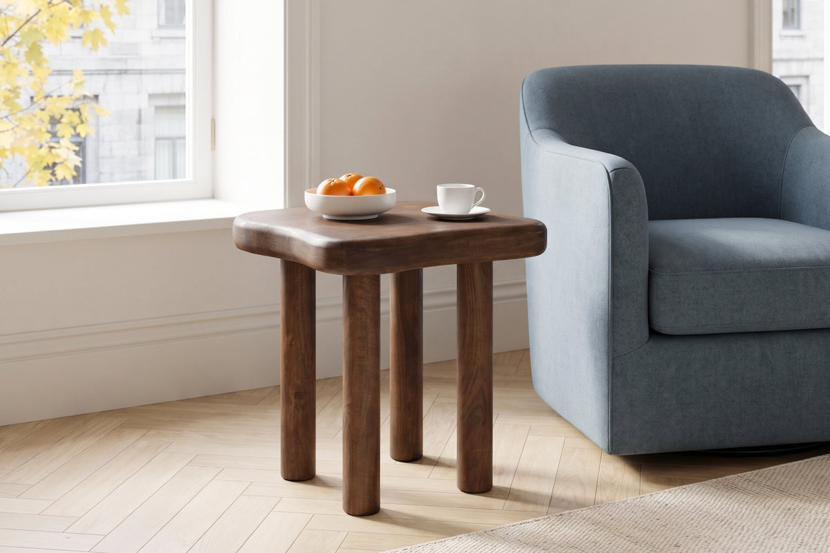 Atri side table in dark walnut beside a dusty-blue wool armchair in a Montreal living room