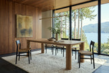 Atzara dining table in a Gibsons house above Howe Sound, with walnut panelling, a glass wall to cedars, firs and the water