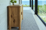 Atzara Small sideboard in Natural seen from the end in a hallway in a Grimsby house, with a board-formed concrete wall