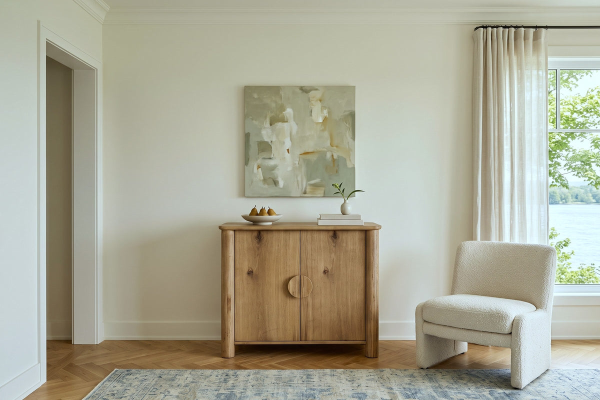 Atzara Small sideboard in Natural against an ivory plaster wall in a Rigaud house
