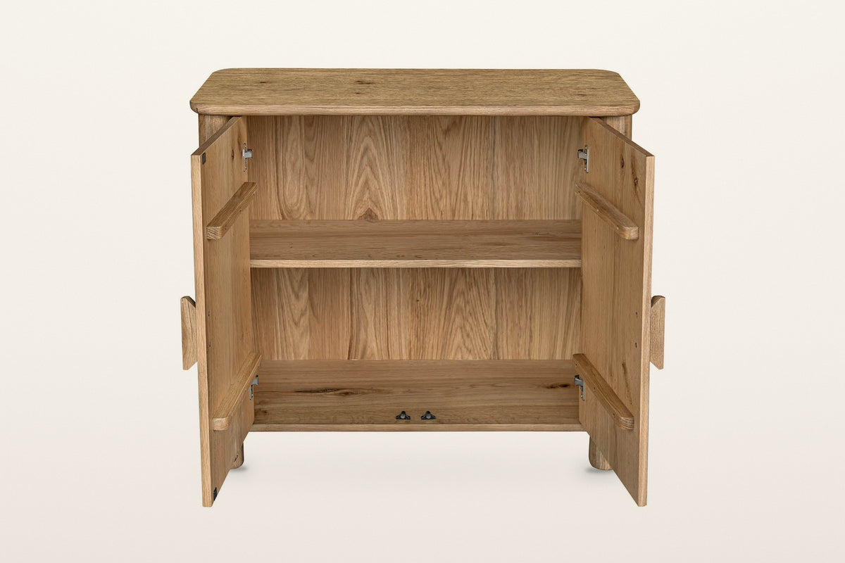 Atzara Small sideboard in Natural with both doors open on a warm white studio backdrop, showing one shelf inside