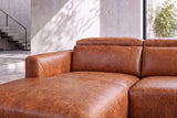 Close-up of the Andria sectional chaise, curved armrest, and adjustable headrests