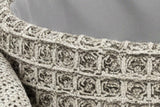 Inside the Balme pouf in Charcoal: the rolled knit rim and the light grey fabric lining