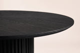 Close-up of the black Bardolino top edge: open-grain wood wedges in a sunburst and a softly rounded edge band