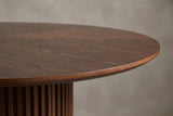 Close-up of the Bardolino top edge: stained wood-grain wedges in a sunburst and a softly rounded edge band