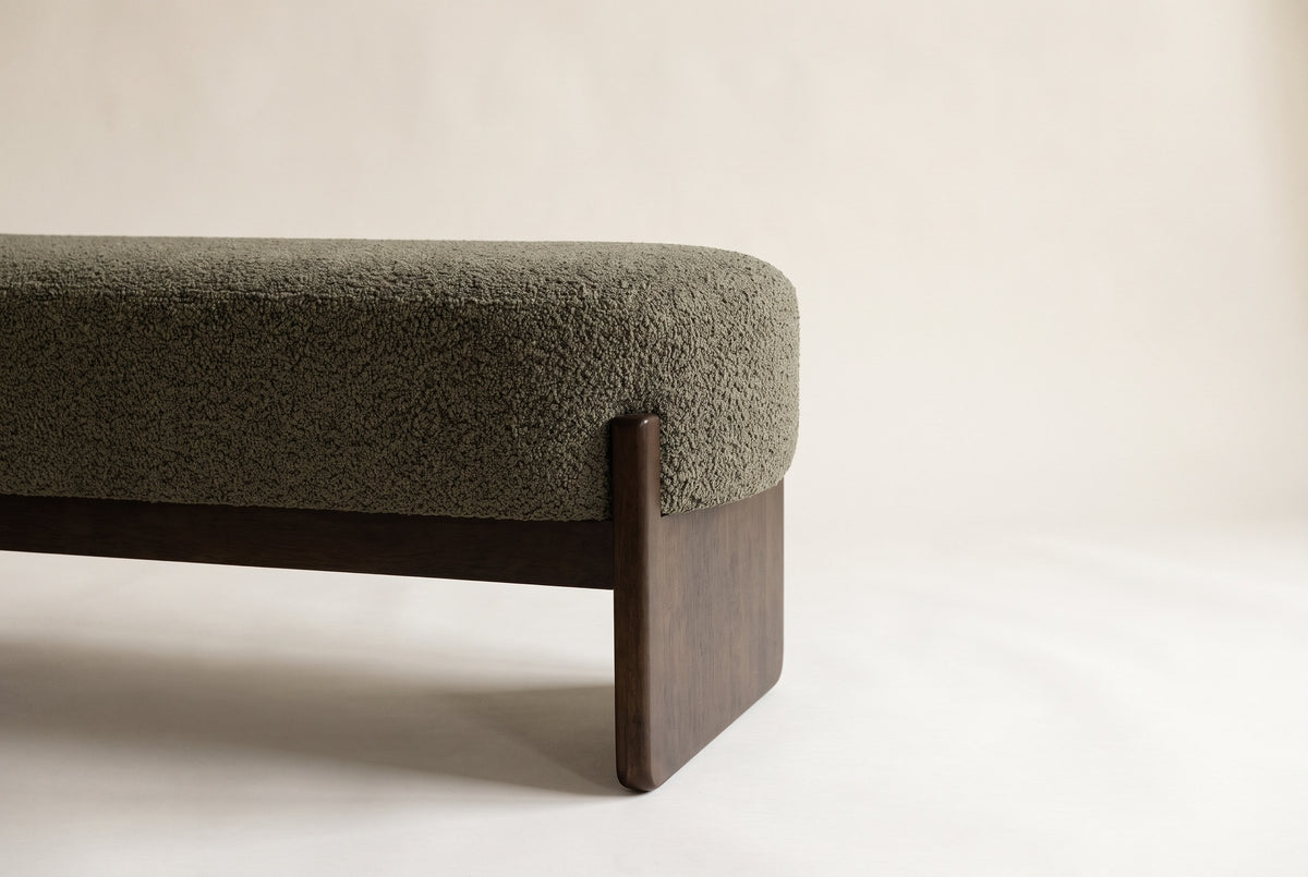 Close-up of the dark green boucle seat, the square rubberwood post and the slab leg