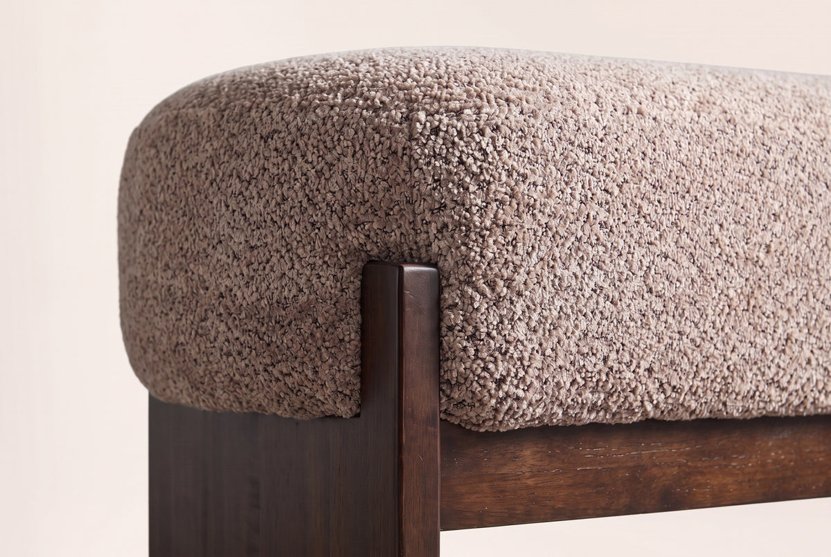 Close-up of the light brown loop-yarn boucle seat, a square rubberwood post and the front rail