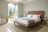 Bassiano bed in Warm Pecan in a bedroom in a Bellagio villa, three-quarter view, with sage plaster