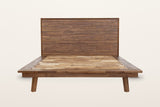Bassiano bed frame in Warm Pecan, front view from the foot on a warm white studio backdrop