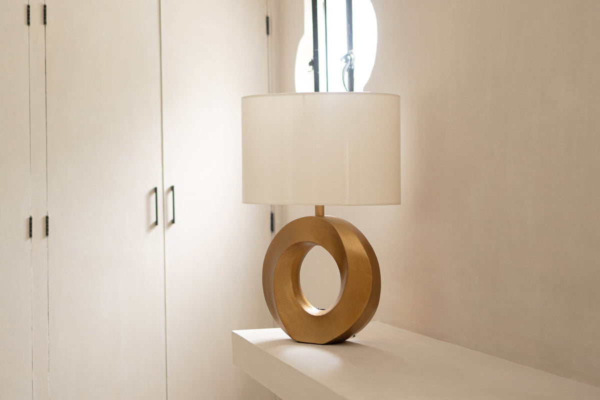 Bastien ring table lamp on a white ledge in a bright hallway