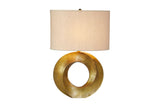 Bastien table lamp switched on, with light glowing through the linen shade