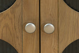 Close-up of Bellamy oak veneer doors and silver-tone round knobs