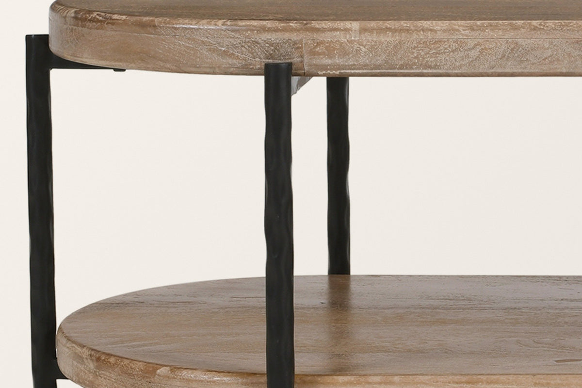 Close view of the Bellano frame: hammered iron rods joined under the thick mango top by short flat bars
