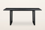 Bernalda dining table in Black, front view on a warm white studio backdrop