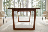 A Bernalda sled frame in Honey Brown at seat height in the Sechelt house, the second frame seen through it