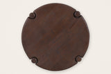 Bettona side table seen from above: the round mango top, its grain and the four leg caps set into notches in the rim
