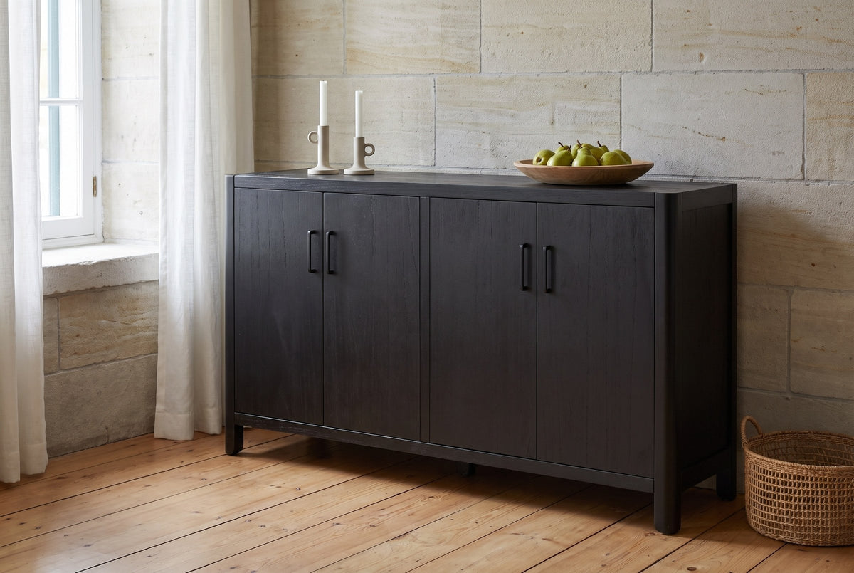 Bibbiena sideboard against a limestone wall in a dining room with pine floorboards, candlesticks and a bowl of pears on top
