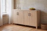 Bibbiena sideboard in Natural against a limestone wall in a dining room with pine floorboards