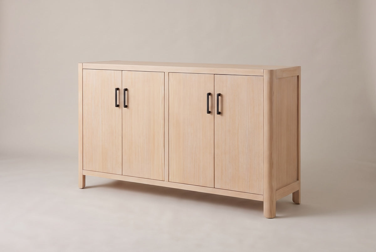 Bibbiena farmhouse 4-door sideboard in Natural, three-quarter view on a warm grey studio backdrop