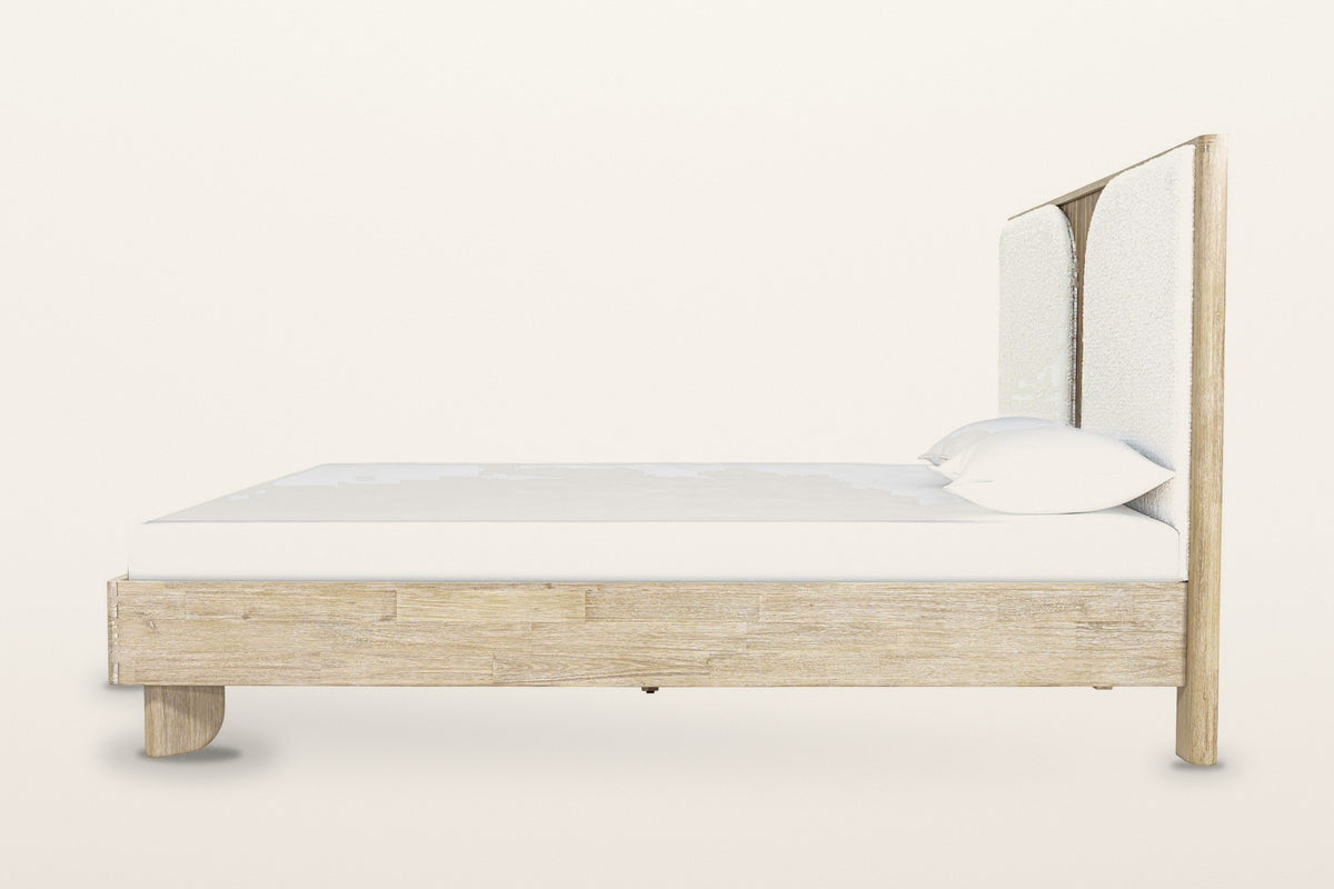 Side view of the Bienno bed on a warm white studio backdrop: the deep box rail