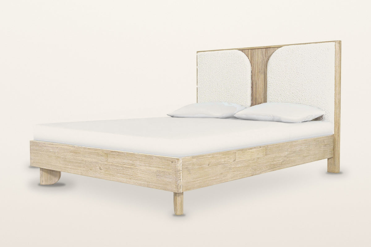 Bienno bed in Sand Wash acacia, three-quarter view on a warm white studio backdrop: a tall flat headboard with two white bouc