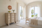 Bienno chest in Sand Wash in a bedroom of a Bordighera villa, with lime plaster walls, a vaulted ceiling