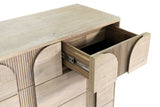 Close-up of a small top drawer of the Bienno chest pulled out: the rounded panel and fluting on its front