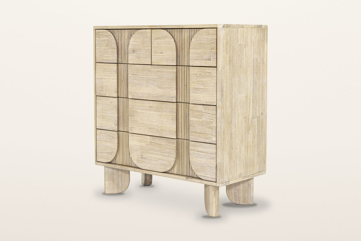 Bienno chest in Sand Wash acacia, three-quarter view on a warm white studio backdrop: five drawers behind rounded panels