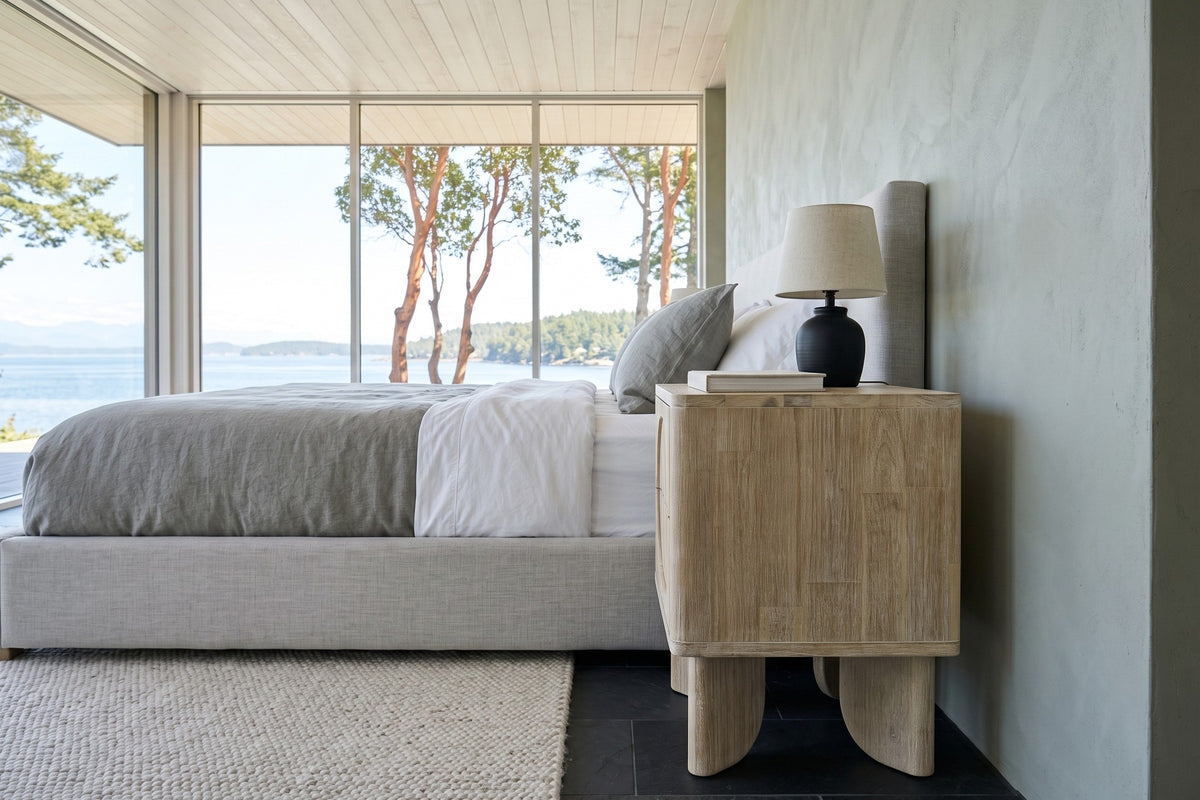 Side view of the Bienno nightstand in Sand Wash in a Chemainus waterfront bedroom, with grey-green clay plaster