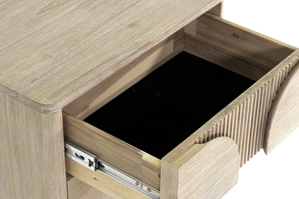 Close-up of a Bienno drawer pulled out on its ball-bearing metal slide, with the fluted drawer front at the right