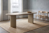 Bobbio dining table in a Halifax dining room with a harbour view, a jute rug and two woven-seat chairs