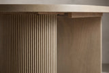 Close-up of a Bobbio pedestal: fine vertical grooves on the curved face, the smooth flat face and the underside of the top