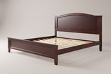 Bolsena arched panel bed in espresso, three-quarter view on a warm light-grey studio backdrop
