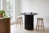 Bolzano table in a bright Vancouver kitchen with two counter stools pulled back and two espresso cups on the top