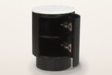 Bomarzo side table in black with its curved door open: one shelf inside the reeded drum
