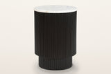 Bomarzo reeded mango wood side table in black with a white marble top, three-quarter view on a warm white studio backdrop