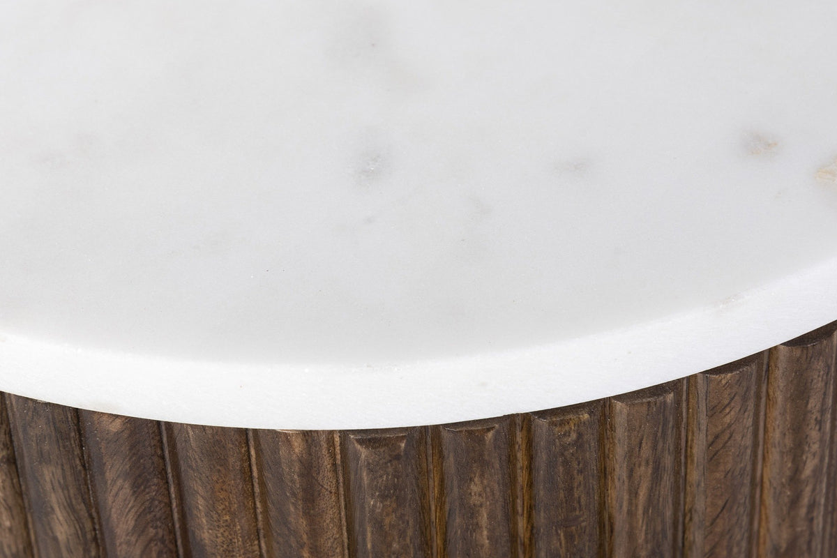 Close-up of the Bomarzo white marble top with its softly eased edge over the reeded mango wood