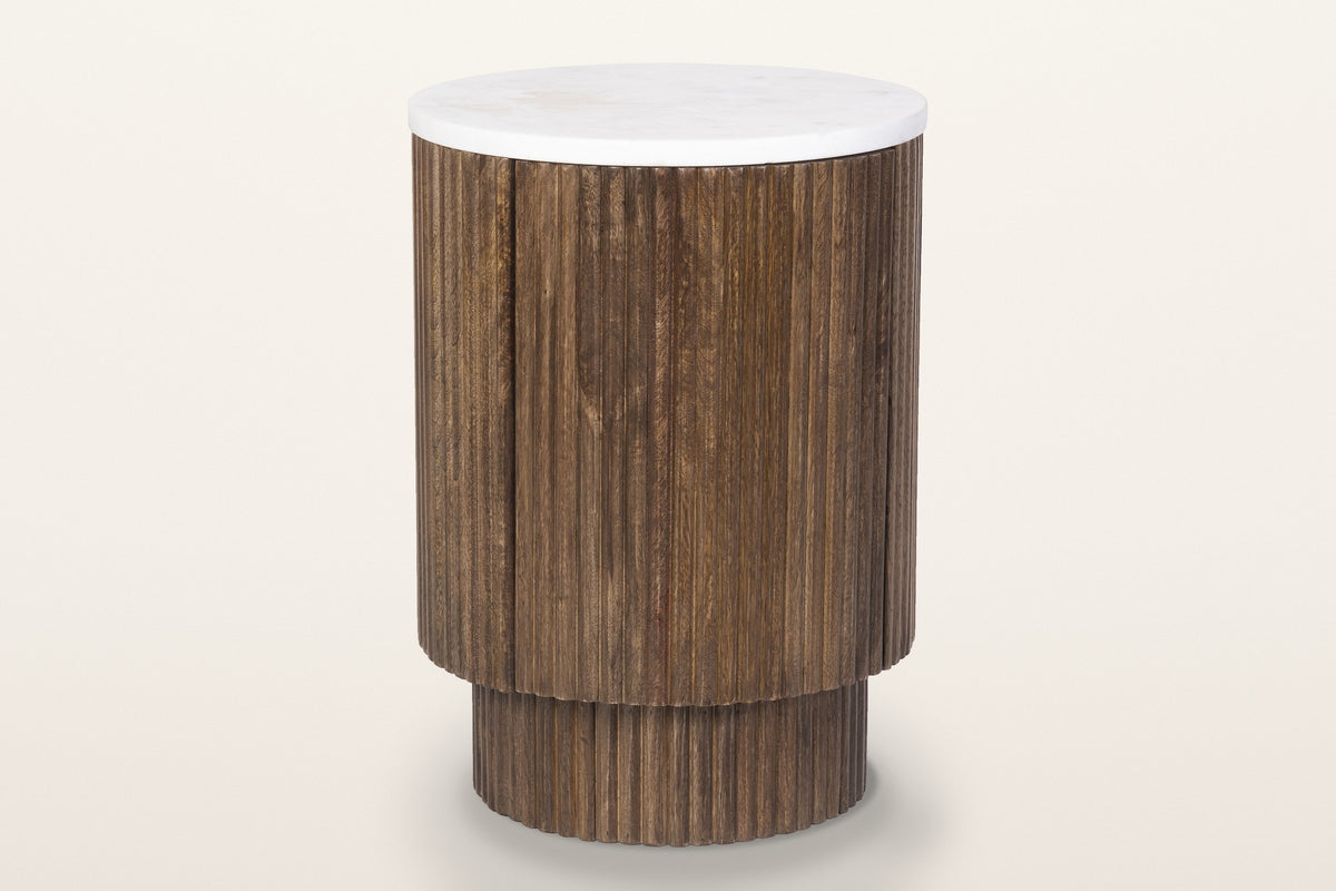 Bomarzo reeded mango wood side table in walnut with a white marble top, three-quarter view on a warm white studio backdrop