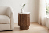Bomarzo side table in walnut beside a cream linen armchair in a Vancouver living room in morning light