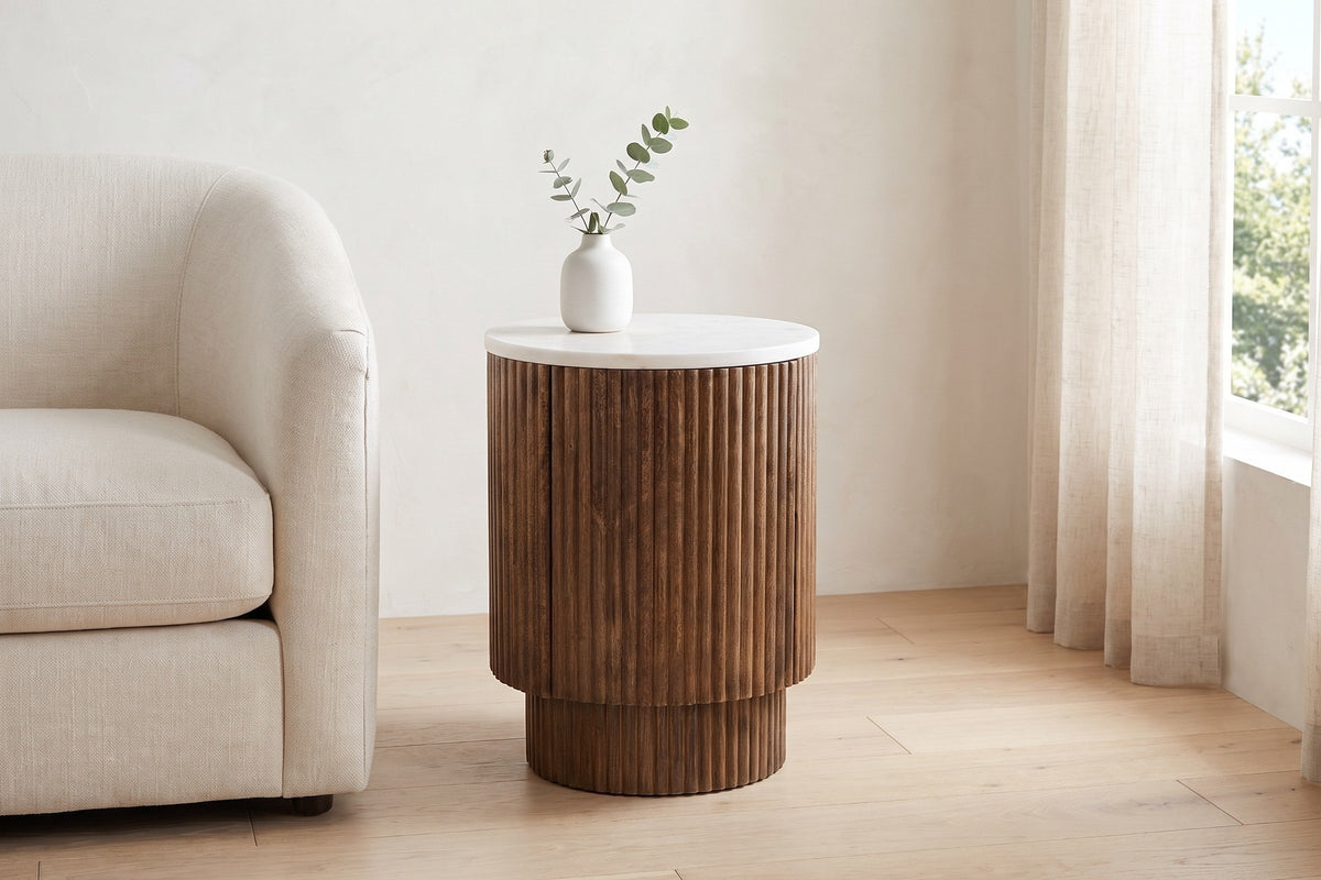 Bomarzo side table in walnut beside a cream linen armchair in a Vancouver living room in morning light