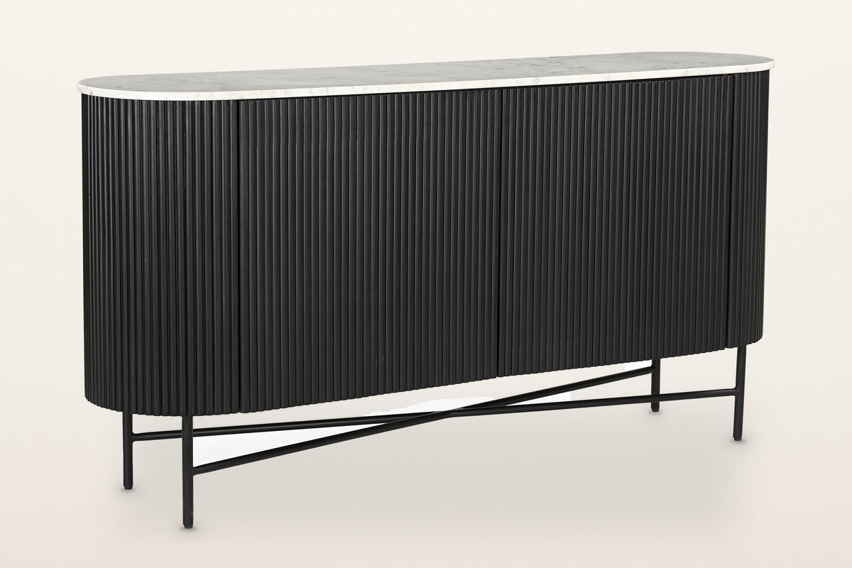 Bomarzo oval sideboard in black: reeded mango wood in a matte black finish, a white marble top and a black metal base, three-quarter view on a warm white studio backdrop