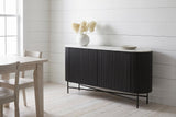 Bomarzo black sideboard against white painted board walls in a Wolfville, Nova Scotia farmhouse dining room, dried hydrangea in a white vase on the marble