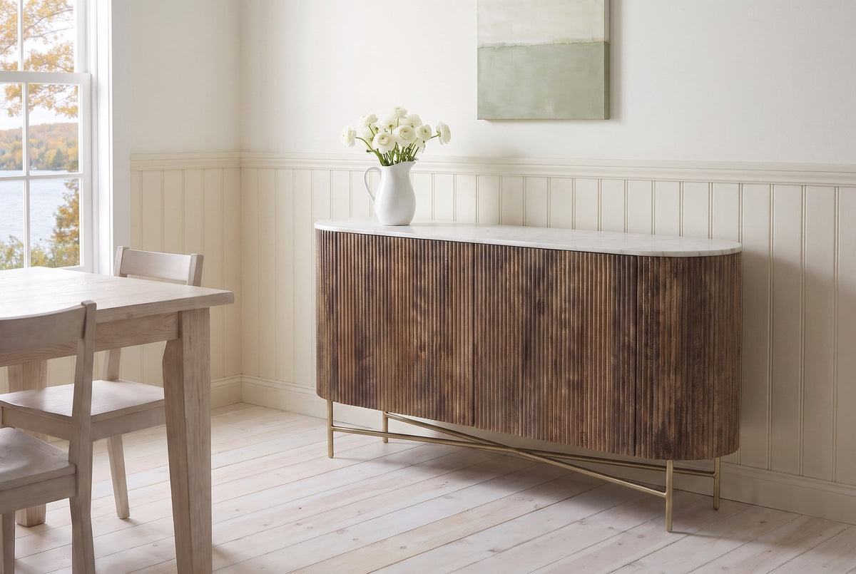 Bomarzo walnut sideboard in a North Hatley lake house dining room with cream panelling, white ranunculus in a pitcher on the marble