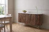 Bomarzo walnut sideboard against a soft greige wall in a Stratford, Ontario dining room with an oak herringbone floor, a bowl of pears on the marble