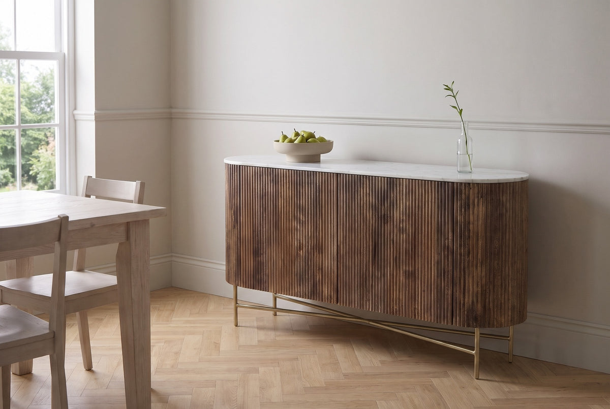 Bomarzo walnut sideboard against a soft greige wall in a Stratford, Ontario dining room with an oak herringbone floor, a bowl of pears on the marble