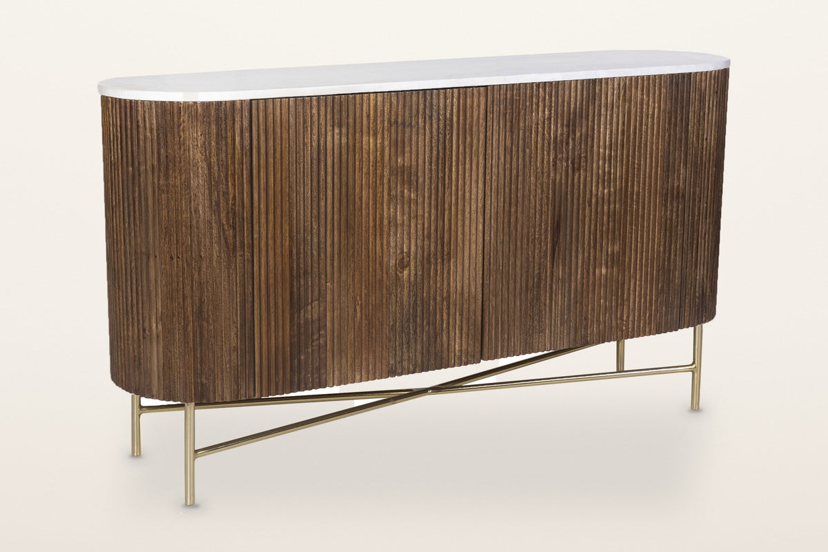 Bomarzo oval sideboard in walnut: reeded solid mango wood, a white marble top and an aged gold base, three-quarter view on a warm white studio backdrop