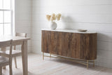 Bomarzo walnut sideboard against white painted board walls in a Wolfville, Nova Scotia farmhouse dining room, dried hydrangea in a white vase on the marble, a pale wood dining table beside it